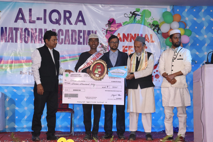 Dilwar Hussain student of AINA receiving Academic Excellence award